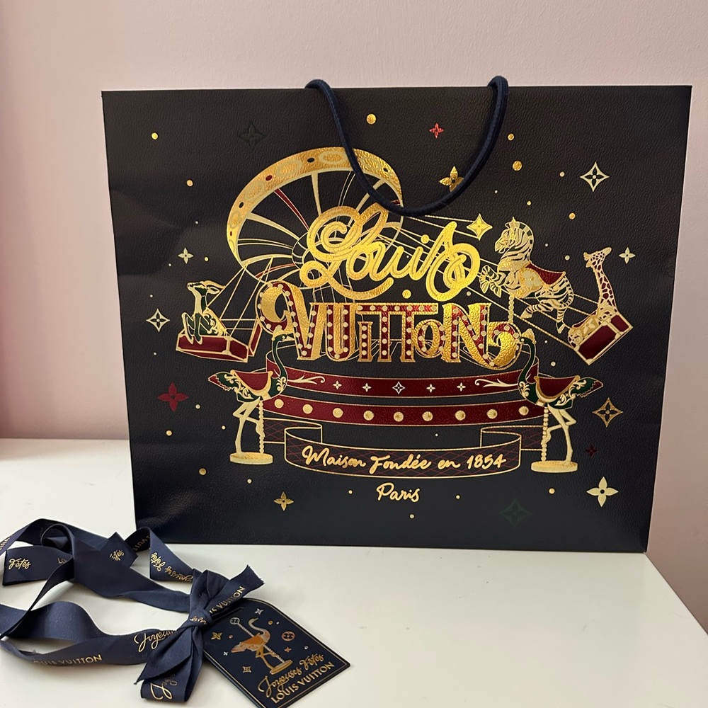 Louis Vuitton Black Bag with Gold and Red Design including gift tag and ribbon.